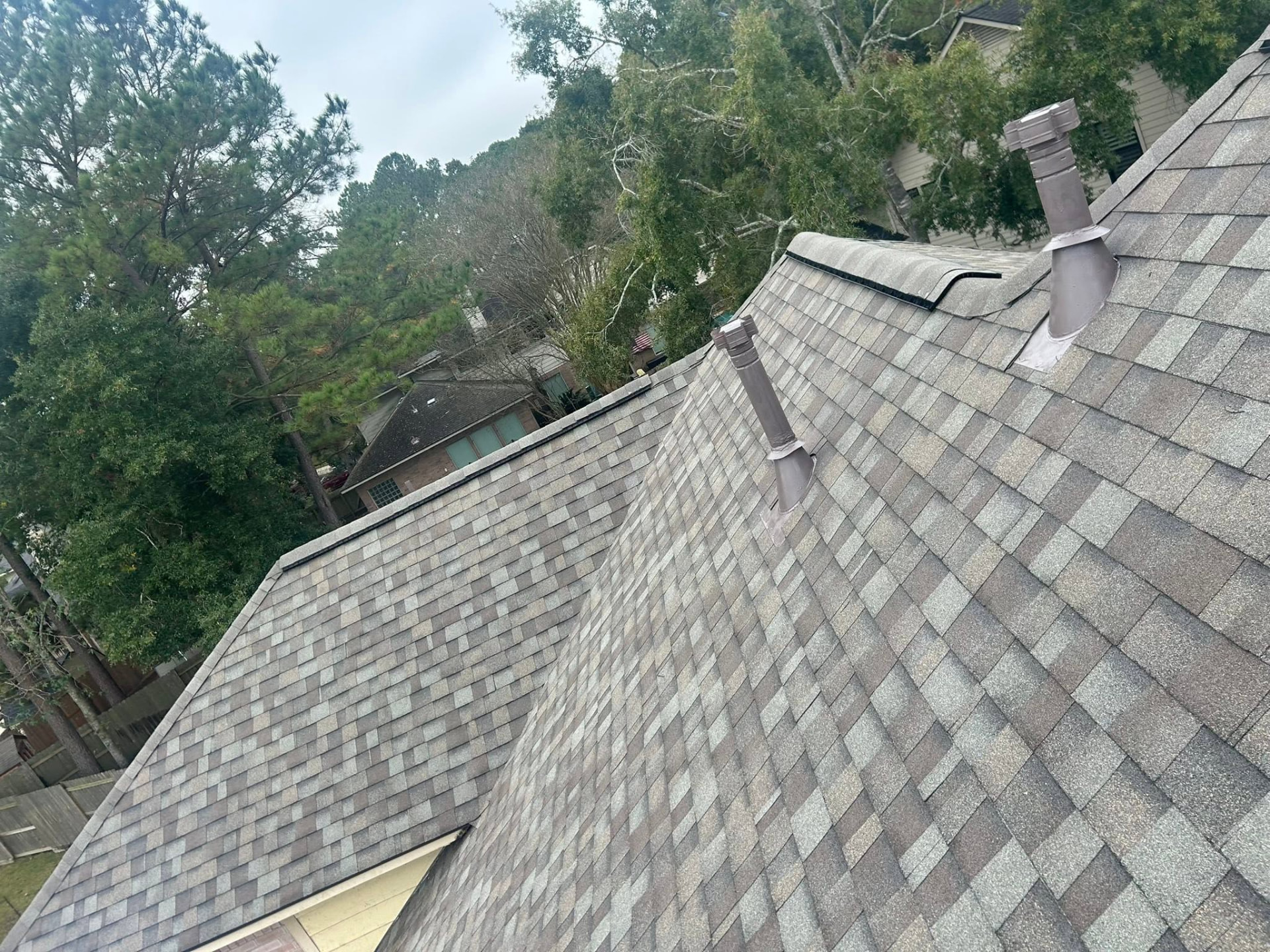 Close detail of finished architectural shingles and roof vents